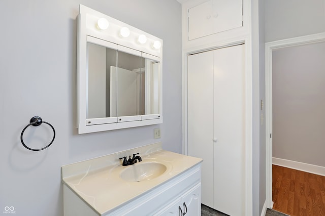 bathroom with hardwood / wood-style flooring and vanity