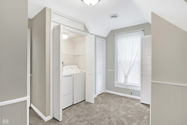 laundry area featuring light colored carpet and independent washer and dryer