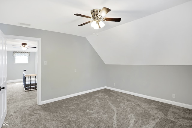 bonus room with vaulted ceiling, ceiling fan, and carpet flooring