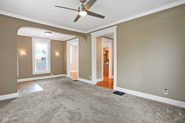 unfurnished room featuring crown molding, ceiling fan, and carpet flooring