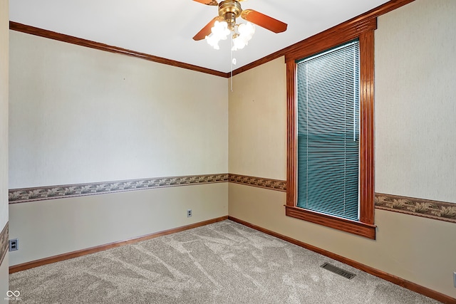 carpeted empty room with ornamental molding and ceiling fan