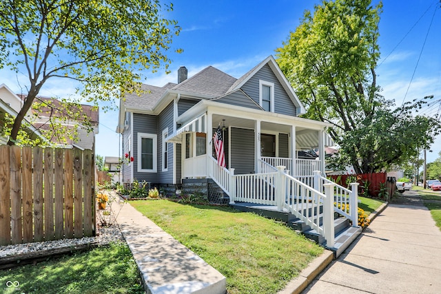 bungalow with a front lawn and a porch