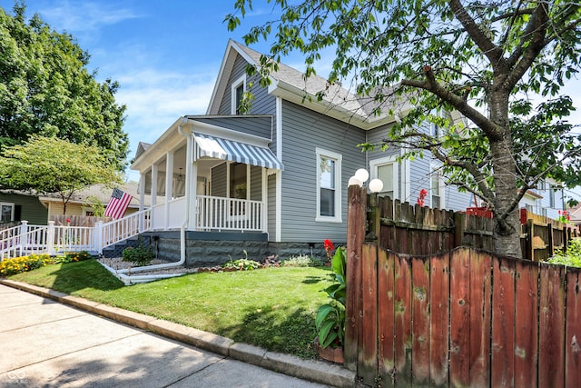 view of front facade with covered porch and a front yard