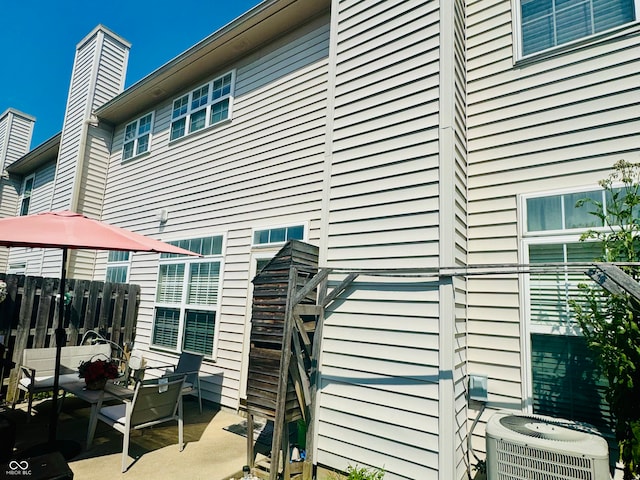 view of side of property featuring a patio and central AC unit