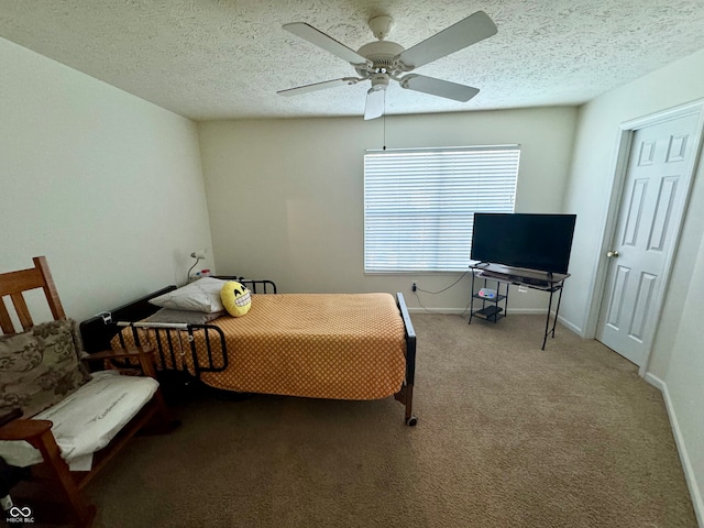 carpeted bedroom featuring a textured ceiling and ceiling fan