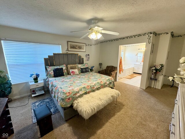 carpeted bedroom with ensuite bath, ceiling fan, and a textured ceiling