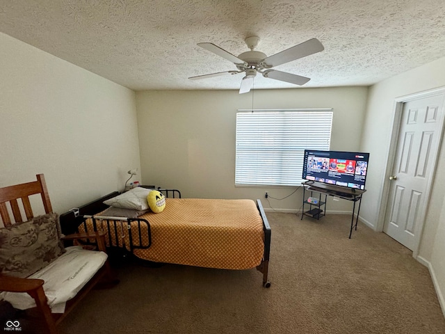 carpeted bedroom featuring a textured ceiling and ceiling fan