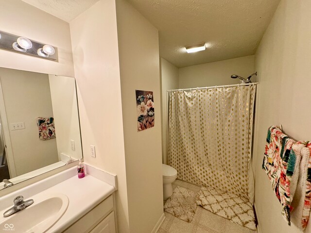 bathroom with vanity, toilet, a textured ceiling, and a shower with shower curtain