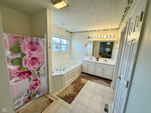 bathroom featuring vanity, a textured ceiling, and a washtub