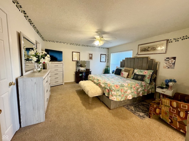 carpeted bedroom featuring a textured ceiling and ceiling fan