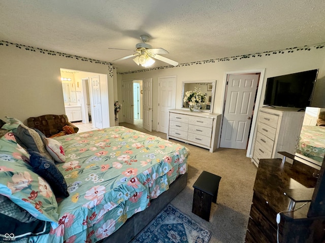 carpeted bedroom with ceiling fan and a textured ceiling