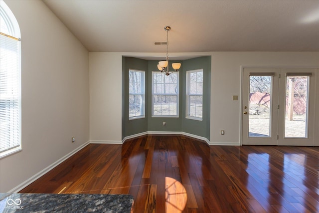 interior space with visible vents, dark wood-style flooring, a chandelier, and baseboards