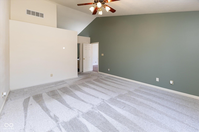 spare room featuring a ceiling fan, baseboards, visible vents, high vaulted ceiling, and light colored carpet