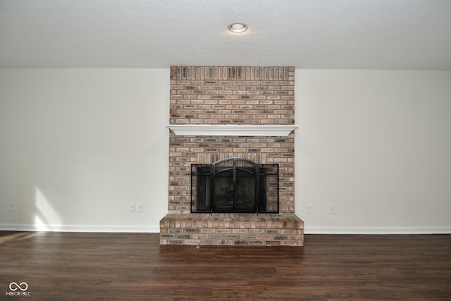 interior details featuring a textured ceiling, a fireplace, and hardwood / wood-style floors