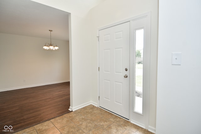 entryway featuring an inviting chandelier and light hardwood / wood-style floors