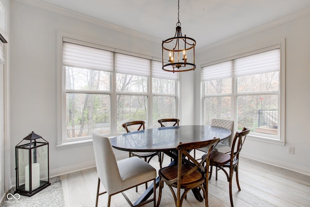 dining area with an inviting chandelier, light hardwood / wood-style flooring, plenty of natural light, and crown molding