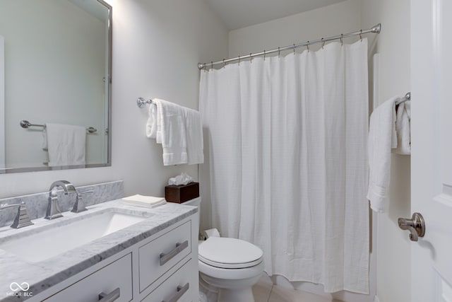 bathroom with tile patterned flooring, vanity, toilet, and walk in shower