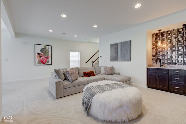 carpeted living room featuring sink