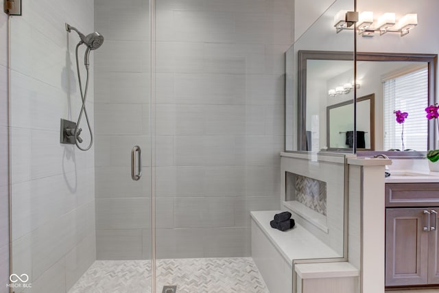 bathroom featuring vanity and a shower with door