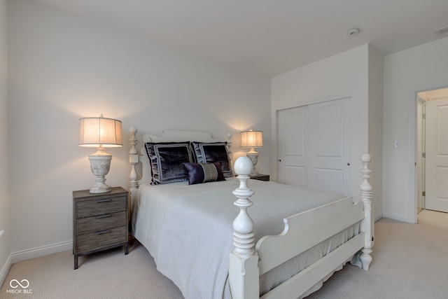 bedroom featuring a closet and light colored carpet