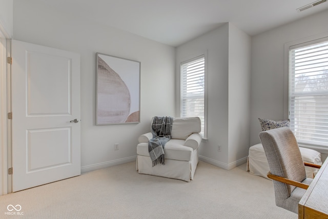 living area with light carpet