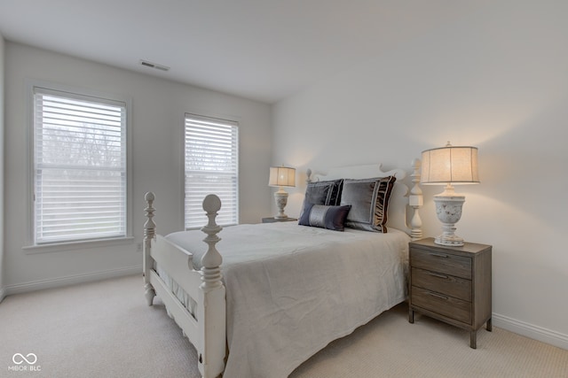 carpeted bedroom with multiple windows