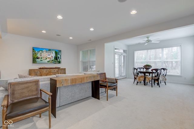 living room featuring light colored carpet and ceiling fan