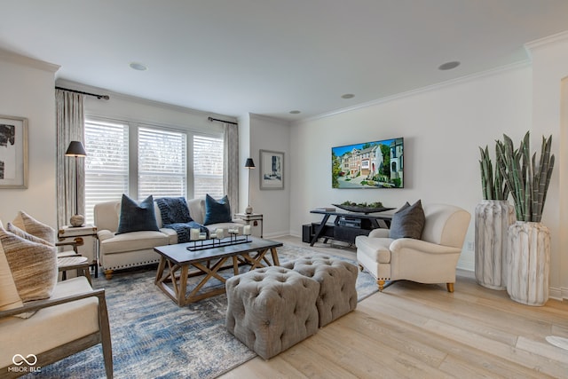 living room featuring crown molding and light hardwood / wood-style floors