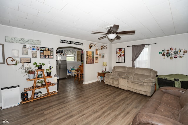 living room featuring ceiling fan and dark hardwood / wood-style floors