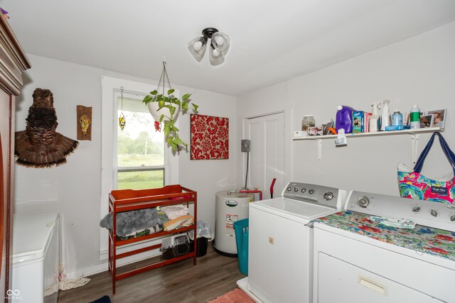 clothes washing area featuring dark wood-type flooring, water heater, and washing machine and clothes dryer