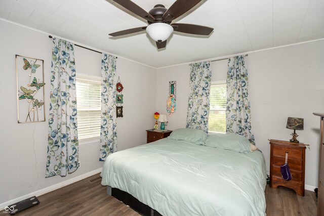 bedroom with ornamental molding, ceiling fan, and dark hardwood / wood-style floors