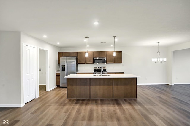 134 Maxim Ct, Cumberland, IN 46229 - kitchen with stainless steel appliances, a sink, light countertops, dark wood finished floors, and baseboards