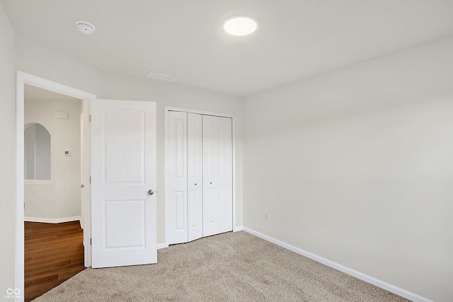 unfurnished bedroom featuring a closet and carpet flooring