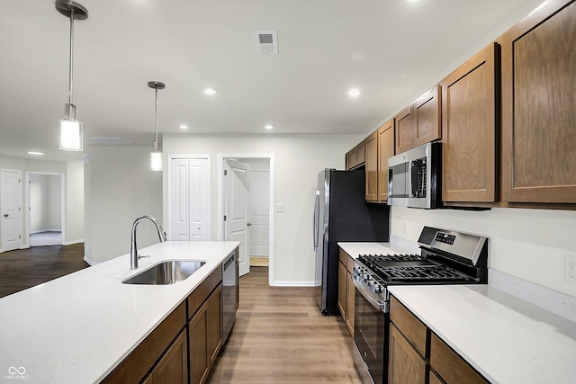134 Maxim Ct, Cumberland, IN 46229 - kitchen with stainless steel appliances, a sink, light countertops, recessed lighting, and wood finished floors
