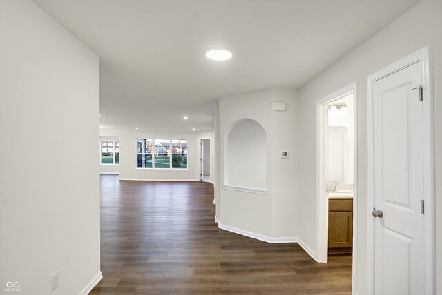 134 Maxim Ct, Cumberland, IN 46229 - hall with dark wood finished floors, a sink, baseboards, and recessed lighting