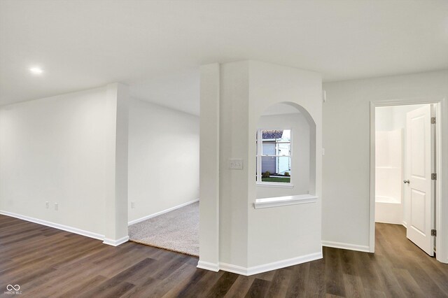 134 Maxim Ct, Cumberland, IN 46229 - spare room featuring dark wood finished floors, arched walkways, and baseboards