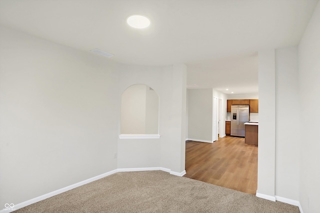 unfurnished room with light wood-type flooring