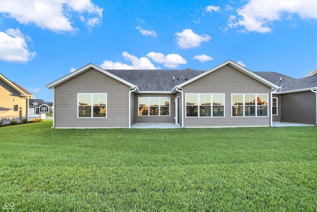 rear view of property featuring a patio area and a yard