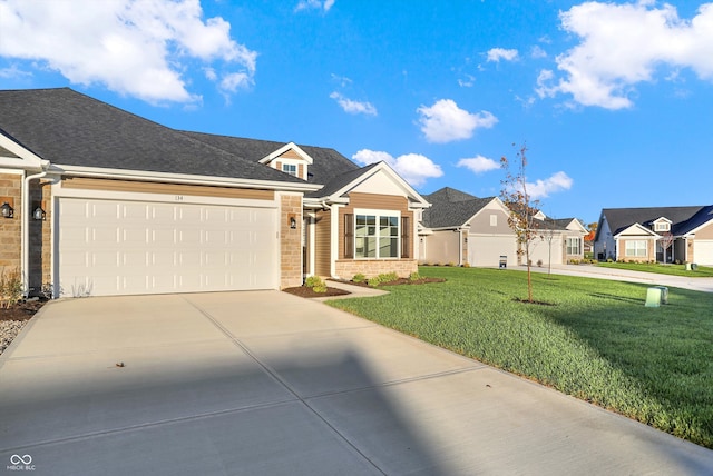 view of front of property with a front yard and a garage