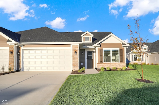 view of front of property featuring a front yard and a garage