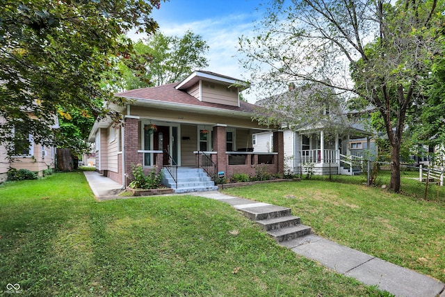 view of front of property with a front yard and covered porch