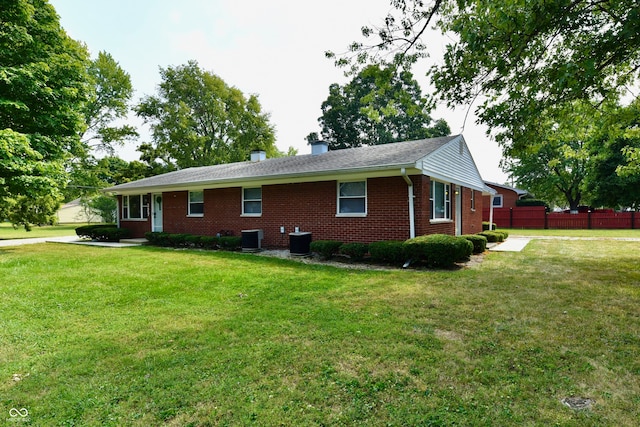 view of home's exterior featuring a yard and cooling unit