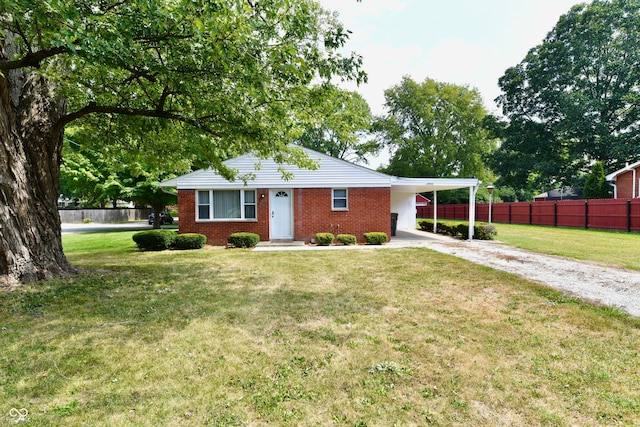 ranch-style house featuring a front lawn and a carport