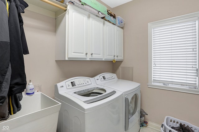 washroom featuring washer and dryer, cabinets, a wealth of natural light, and sink