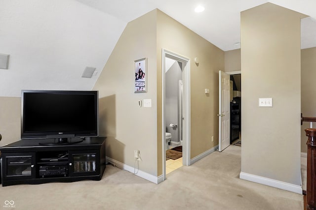 living room featuring light carpet and vaulted ceiling