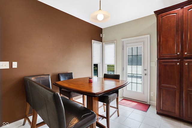 tiled dining area featuring a fireplace