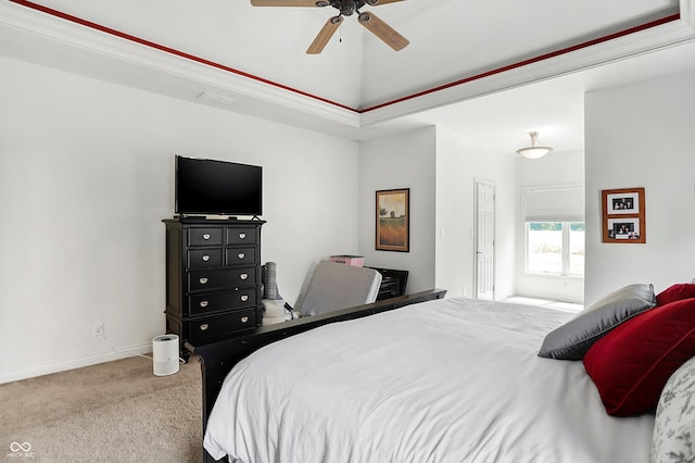 bedroom with carpet flooring, ceiling fan, and a raised ceiling