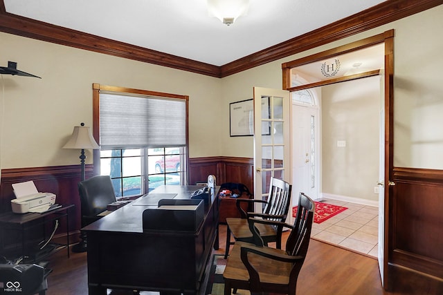 office featuring a wainscoted wall, wood finished floors, and crown molding