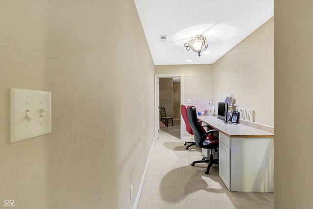 office with baseboards, visible vents, and light colored carpet