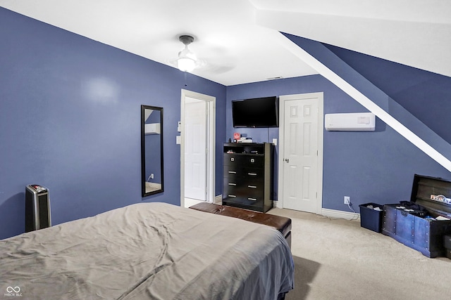 bedroom with ceiling fan, a wall unit AC, and carpet